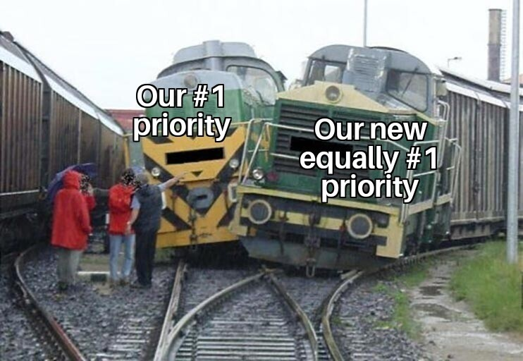 project management meme: a train wreck happening because of two competing priorities